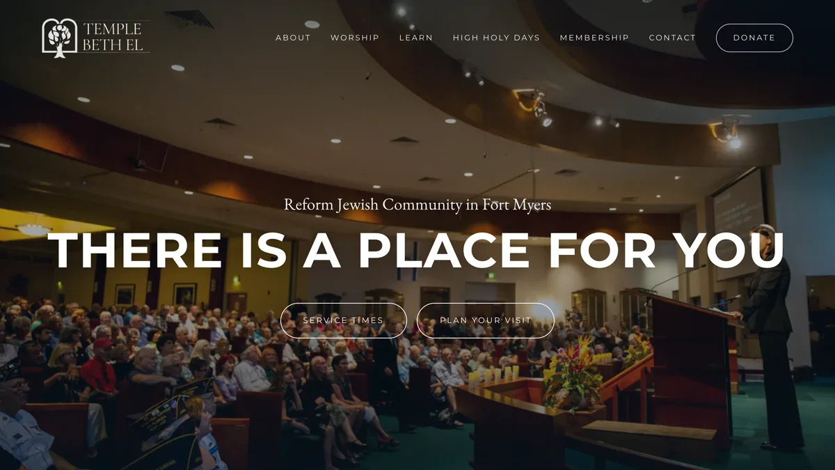 Temple Beth El homepage: the headline There is a place for you in tall white capitals over a full width photograph of a full congregation seated in the sanctuary.